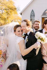 Bride at reception dancing and singing while wearing pink sunglasses