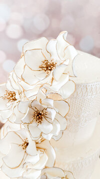 styling sugar flowers on a wedding cake close up