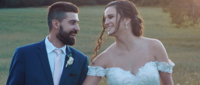 A newlywed couple smiling and looking at each other 