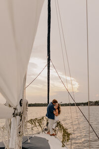 wedding portraits on a sailboat at sunset after their gulf shores beach wedding ceremony