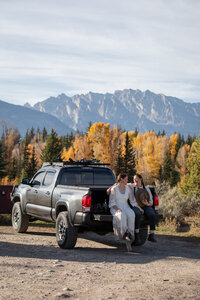 Newlyweds hug and enjoy the views of peaks and glaciers after a beautiful elopement ceremony in Glacier National Park.