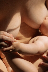 Woman nursing her newborn in beautiful light