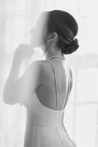 Bride with a sleek, polished low bun — luxury bridal hair look styled by Klover Beauty for a classic Maryland wedding.