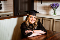 Senior grad headshot with arms crossed and smiling at camera