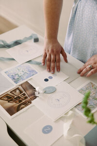 Wedding planner, Zelie & Co., arranging a wedding invitation suite flat lay