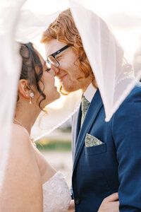 Bride and groom smiling during sunset portraits | Fresno photographer Ashley Norton