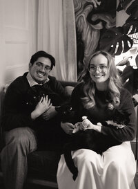 35mm film photo of Dominique and Javi laughing together while baking in their kitchen, standing behind a decorated cake — the film wedding photographer duo behind Castillo Holliday Photo + Film, known for analog wedding films and Super 8 wedding films.