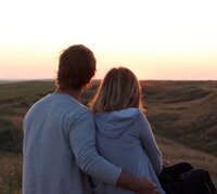 Couple watching the sunset while hugging representing the happiness you can experience after participating in betrayal trauma recovery program with Relationship Experts based in Florida, US