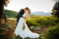 Jackson Hole photographers capture groom holding bride during outdoor portraits
