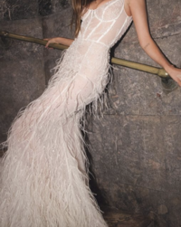 Model in a studio wearing a silk bridal dress by Sandra Mansour