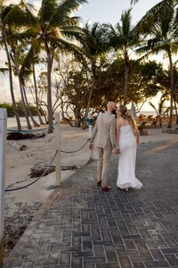 Kissing on a pathway at Cayo Levantado in the Dominican republic for a destination elopement
