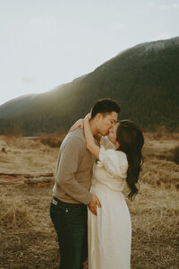romantic maternity photos in front of a mountain