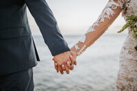 couple holding hands during beach elopement