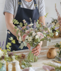 Floral designer arranging a bouquet.