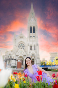 college senior in front of Francis Xavier church with tulips in foreground