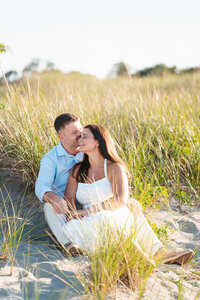Sunset engagement session at Good Harbor Beach in Gloucester, Massachusetts with natural, candid moments.
