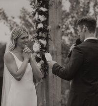 Married couple on their wedding day taking photos in the fall in a private backyard