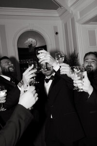 A toast for the groomsmen moments before the ceremony at Penn Ryn Mansion. Taken with an editorial flare and flash. 