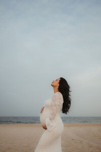 Expectant mother during a peaceful maternity photo session on the beach in Pennsylvania