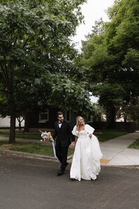 Film photo of bride and groom walking hand in hand at TRICA wedding venue by idaho wedding photographer