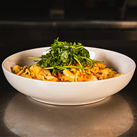 Pasta with chicken thigh, bacon, butternut squash, leeks, white wine sauce, arugula, fresno honey Max Dales Steak and Chop House Restaurant