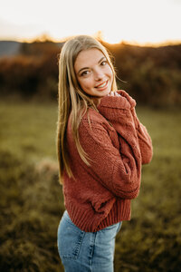 A senior girl illuminated by the golden hour, capturing her grace and potential, photographed in Vermont.