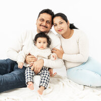 Image of new parents with their baby at a studio newborn photography session by Hobart Newborn Photographer, Lauren Vanier