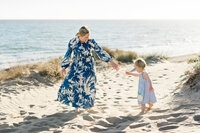 mum-playing-with-child-on-beach