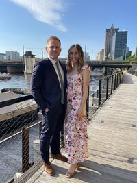 milwaukee event planners, Molly, poses with her husband in a grassy area.