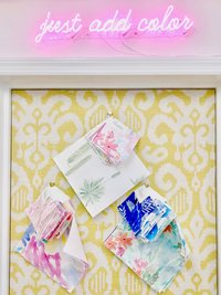 A pink neon sign to just add color above a yellow damask bulletin board.