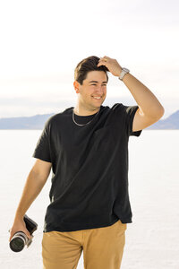 Jordan Tacker Photographer and Videographer holding camera