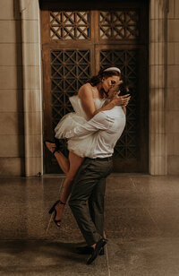 A couple kissing as the groom holds the bride in the air at their Nashville Tennessee elopement.
