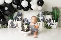 newborn baby girl wrapped in mint with greenery and florals