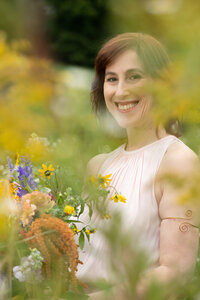 Jennifer Hendler smiling in blurred image holding flowers
