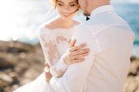 bride-groom-are-hugging-rocky-beach-mamula-island-min