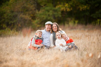 Fall family portrait in tall grass field