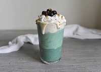 Fruity smoothie with whole blueberries placed on top