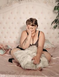 Elegant boudoir photo session in a Minneapolis studio with soft natural lighting.