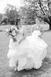 a groom helping the bride with her dress
