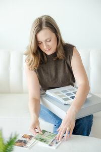 girl holds wedding albums