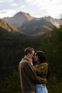 Engagement session with a couple getting married with a mountain view backdrop in Granby Colorado near vail
