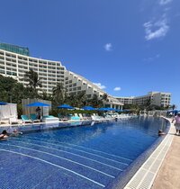 A stunning beach resort pool view, offering a romantic atmosphere for weddings, surrounded by lush tropical scenery.