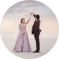 Couple in traditional Indian clothing at sunset laughing at the Salt Flats