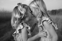Sisters press their foreheads to each other