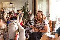 woman smiling at group talking