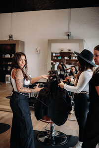 Jaycie, founder of The Jaycie Collective, standing in her luxury salon—showcasing her expertise in creating a high-end, modern client experience.