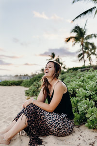 woman sitting on the  beach smiling