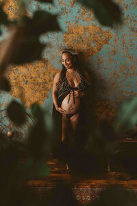 photo of a pregnant woman leaning on the wall