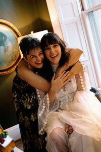 Bride and her mom getting ready before wedding