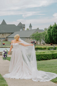 A bride holding her dress at Castle Farms in Charlevoix